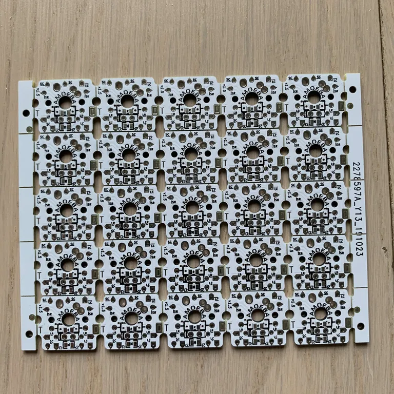 A break-away panel of twenty-five Amoeba single-switch PCBs, each with its diode already on board